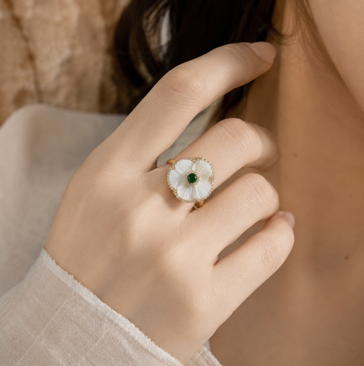 Mother of pearl ring with floral shell design, crystal accents, and delicate coastal jewelry mood.