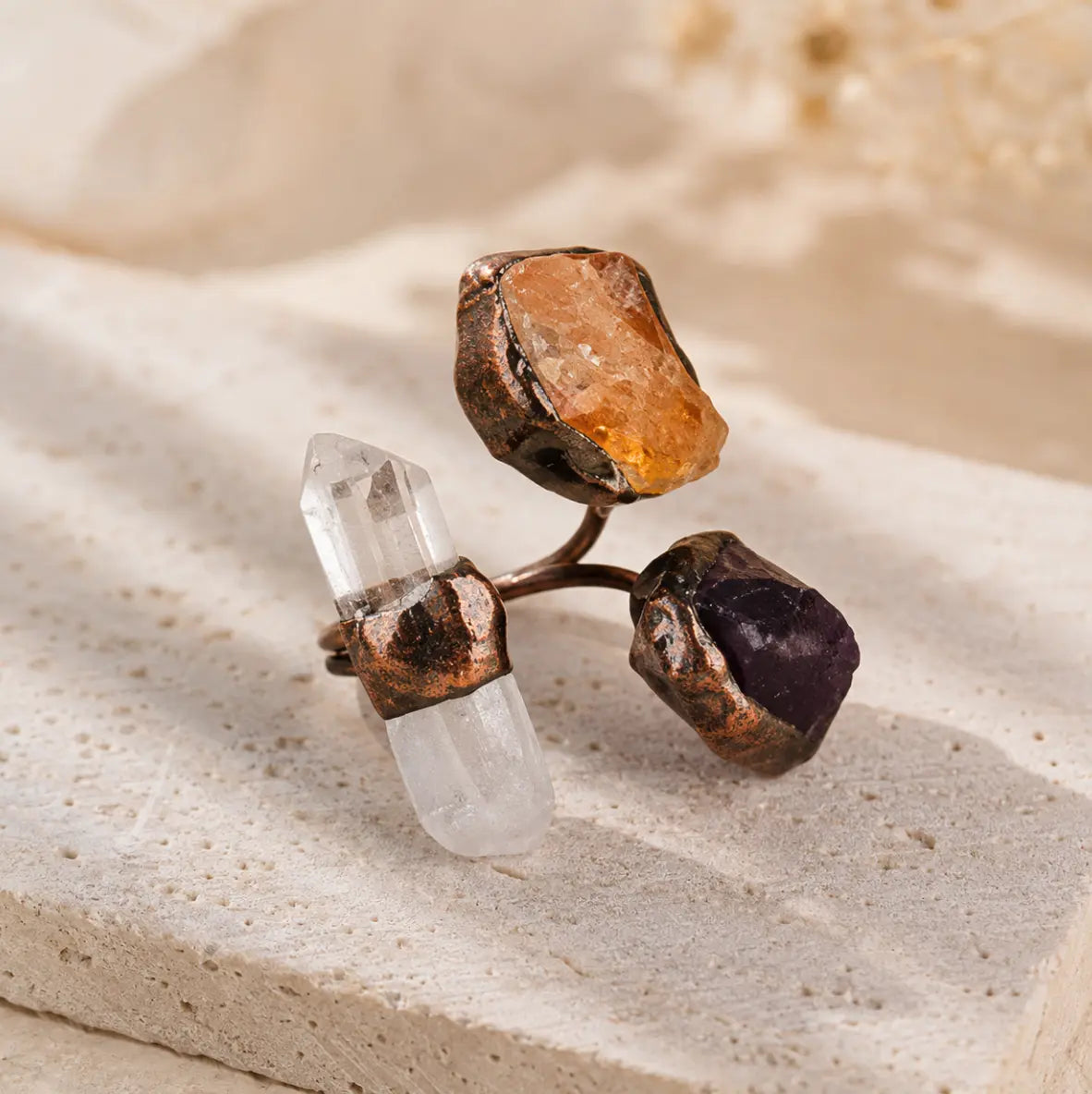 Amethyst citrine quartz ring with raw purple, golden, and clear crystal stones in an artistic open design.