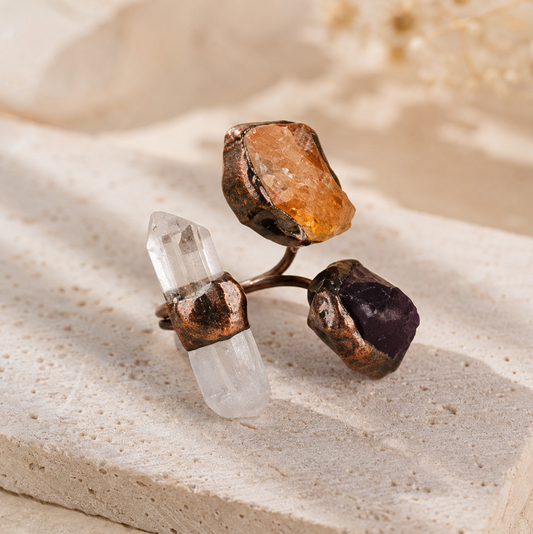Amethyst citrine quartz ring with raw purple, golden, and clear crystal stones in an artistic open design.