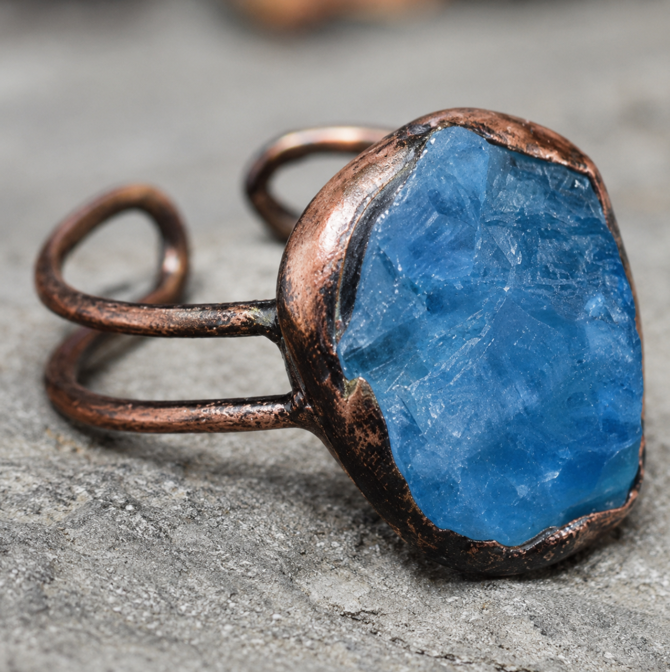 Lake blue gemstone ring with natural mineral texture, organic setting, and quiet feminine elegance.