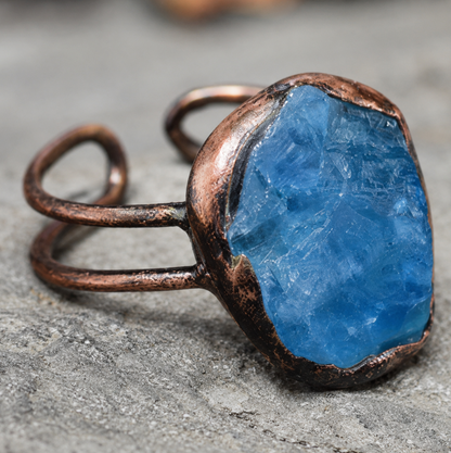 Lake blue gemstone ring with natural mineral texture, organic setting, and quiet feminine elegance.