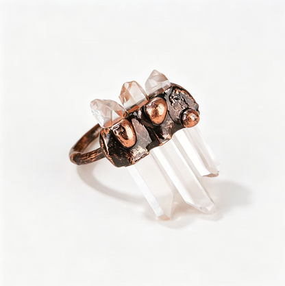 Artistic raw crystal ring featuring vertical quartz towers and a sculptural handcrafted copper band.