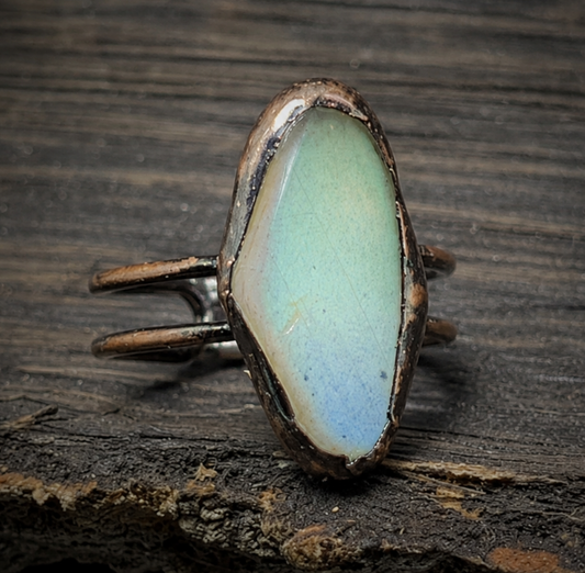 Moonstone ring for women displayed on moss and stone with soft forest-inspired styling.