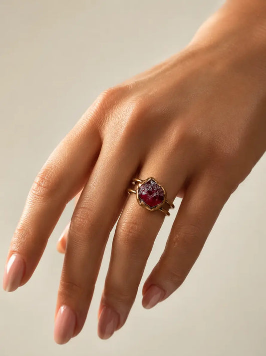 January birthstone ring styled on the hand with rich red gemstone color and quiet statement mood.