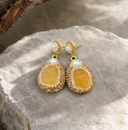 Romantic citrine dangle earrings with warm tone crystal, pearl top detail, and soft luxury styling.